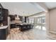 Modern kitchen with center island featuring seating and stainless steel appliances and adjacent dining room at 7897 S Jamestown Ct, Aurora, CO 80016