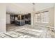 Spacious kitchen and dining room area featuring an island with seating and stainless steel appliances at 7897 S Jamestown Ct, Aurora, CO 80016