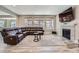 Spacious living room featuring a fireplace, a large sectional sofa, and lots of natural light at 7897 S Jamestown Ct, Aurora, CO 80016