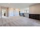 Open loft area featuring neutral carpeting, natural lighting, and a wrought iron railing at 7897 S Jamestown Ct, Aurora, CO 80016