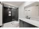 Modern bathroom showcasing a stylish vanity with marble counters and a glass enclosed shower at 424 Arbor Dr, Lafayette, CO 80026