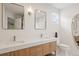Well-lit bathroom boasts a double vanity, stylish mirrors, and modern fixtures at 424 Arbor Dr, Lafayette, CO 80026
