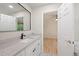 Bright bathroom features a modern vanity and a stylish mirror reflecting the open bedroom at 424 Arbor Dr, Lafayette, CO 80026