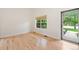 Bright bedroom with wood floors, window with shade, and a door leading to the outside at 424 Arbor Dr, Lafayette, CO 80026