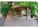 Expansive deck features beautiful wood flooring and a pergola with privacy drapes at 424 Arbor Dr, Lafayette, CO 80026