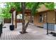 Expansive deck features beautiful wood flooring and pergola with tree growing through the center at 424 Arbor Dr, Lafayette, CO 80026