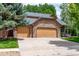 Spacious home featuring an attached three-car garage with stone facade and ample driveway space at 424 Arbor Dr, Lafayette, CO 80026