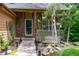Charming stone-accented home entrance with landscaped walkway and cozy porch seating at 424 Arbor Dr, Lafayette, CO 80026