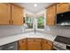 Corner kitchen shot featuring white countertops, wood cabinets, and tile backsplash at 424 Arbor Dr, Lafayette, CO 80026