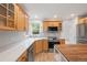 Bright kitchen features wood cabinets, stainless appliances, and white countertops at 424 Arbor Dr, Lafayette, CO 80026
