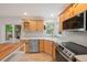 Stylish kitchen includes stainless appliances, natural wood cabinets, and a breakfast bar at 424 Arbor Dr, Lafayette, CO 80026