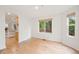 Inviting living area with wood flooring, large windows, and open flow to the bar and kitchen at 424 Arbor Dr, Lafayette, CO 80026