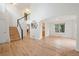 Open-concept living space with hardwood flooring, high ceilings and staircase with black and white spindles at 424 Arbor Dr, Lafayette, CO 80026