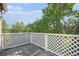 Outdoor deck area surrounded by mature trees offers relaxation and privacy at 360 S Estes St # C, Lakewood, CO 80228
