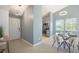 Inviting dining area next to a kitchen with a modern light fixture and natural lighting at 360 S Estes St # C, Lakewood, CO 80228