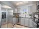 Kitchen features stainless steel appliances, granite countertops, and backsplash with natural light at 360 S Estes St # C, Lakewood, CO 80228