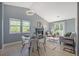 Open-concept living and dining room featuring a fireplace, lots of light and stylish modern decor at 360 S Estes St # C, Lakewood, CO 80228