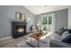 Cozy living room featuring a fireplace, comfortable seating, and a stylish coffee table at 360 S Estes St # C, Lakewood, CO 80228