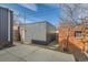 View of the backyard and shed, with a brick wall bordering the property line at 3439 N High St, Denver, CO 80205