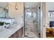 Contemporary bathroom featuring dual sinks, marble accents, and a glass-enclosed shower for a modern design at 3439 N High St, Denver, CO 80205