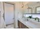 Luxurious bathroom with dual sinks, wood cabinets, quartz countertops, and modern fixtures for an elegant touch at 3439 N High St, Denver, CO 80205