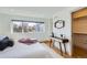 Well-lit bedroom with hardwood floors, a modern table, and a neutral color scheme with a walk in closet at 3439 N High St, Denver, CO 80205