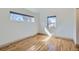 Bright bedroom features hardwood floors and natural light from two windows with modern trim at 3439 N High St, Denver, CO 80205