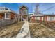 Modern two-story home with sleek design, balcony, and well-maintained walkway leading to the front entrance at 3439 N High St, Denver, CO 80205