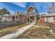 Modern home with a metal facade, small balcony, and a walkway leading to the front door at 3439 N High St, Denver, CO 80205