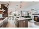 Open-concept kitchen flowing into the living and dining areas, featuring an island with seating at 3439 N High St, Denver, CO 80205