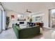 Spacious living room with a green sofa, fireplace, and stylish decor, bathed in natural light at 3439 N High St, Denver, CO 80205