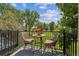 Charming balcony with woven chairs and a table, overlooking a lush green golf course at 2945 W Riverwalk Cir # B, Littleton, CO 80123
