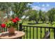 Balcony view featuring wrought iron railing and a charming red potted plant, overlooking the community grounds at 2945 W Riverwalk Cir # B, Littleton, CO 80123