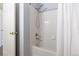 Clean, white bathroom featuring a shower and tub combo, white tile surround, and a white shower curtain at 2945 W Riverwalk Cir # B, Littleton, CO 80123