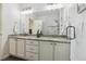 Bathroom featuring a double vanity, granite countertop, and glass-enclosed shower at 2945 W Riverwalk Cir # B, Littleton, CO 80123