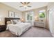 Inviting bedroom with a large window, ceiling fan, and neutral decor at 2945 W Riverwalk Cir # B, Littleton, CO 80123