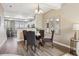 Cozy dining area featuring a glass table, neutral color palette, and elegant lighting at 2945 W Riverwalk Cir # B, Littleton, CO 80123