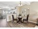 Dining area with a glass table, set against a backdrop of neutral walls and light-filled rooms at 2945 W Riverwalk Cir # B, Littleton, CO 80123