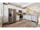 Bright kitchen featuring stainless steel appliances, white cabinets, and wood floors at 2945 W Riverwalk Cir # B, Littleton, CO 80123