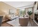 Bright living room with plush seating and a balcony offering serene outdoor views at 2945 W Riverwalk Cir # B, Littleton, CO 80123