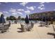 Community pool area with lounge seating, tables with umbrellas, and views of the townhome buildings at 2945 W Riverwalk Cir # B, Littleton, CO 80123