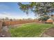 Expansive backyard with a lush lawn, mature trees, and a wooden fence offering privacy at 367 Jupiter Dr, Lone Tree, CO 80124