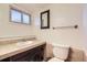 Functional bathroom with a tiled vanity, mirror, and toilet offering essential amenities at 367 Jupiter Dr, Lone Tree, CO 80124