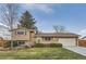 Charming home with a well-maintained front yard, lush lawn, and attached two-car garage at 367 Jupiter Dr, Lone Tree, CO 80124
