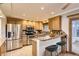 Well-equipped kitchen featuring stainless steel appliances, light wood cabinets, and a breakfast bar with seating at 367 Jupiter Dr, Lone Tree, CO 80124