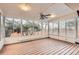 Bright sunroom with wood floors and large windows, providing ample natural light and views of the surrounding landscape at 367 Jupiter Dr, Lone Tree, CO 80124