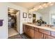 Bathroom boasting double vanity with granite countertop, walk-in closet and well-lit mirror at 8165 E Lowry Blvd # 310, Denver, CO 80230