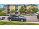 Exterior view of the building with colorful siding and well-maintained landscaping, parked cars in front at 8165 E Lowry Blvd # 310, Denver, CO 80230