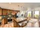 Modern kitchen with stainless appliances and center island overlooking living room at 8165 E Lowry Blvd # 310, Denver, CO 80230