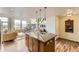 Gourmet kitchen with island, pendant lights, and staircase access at 8165 E Lowry Blvd # 310, Denver, CO 80230